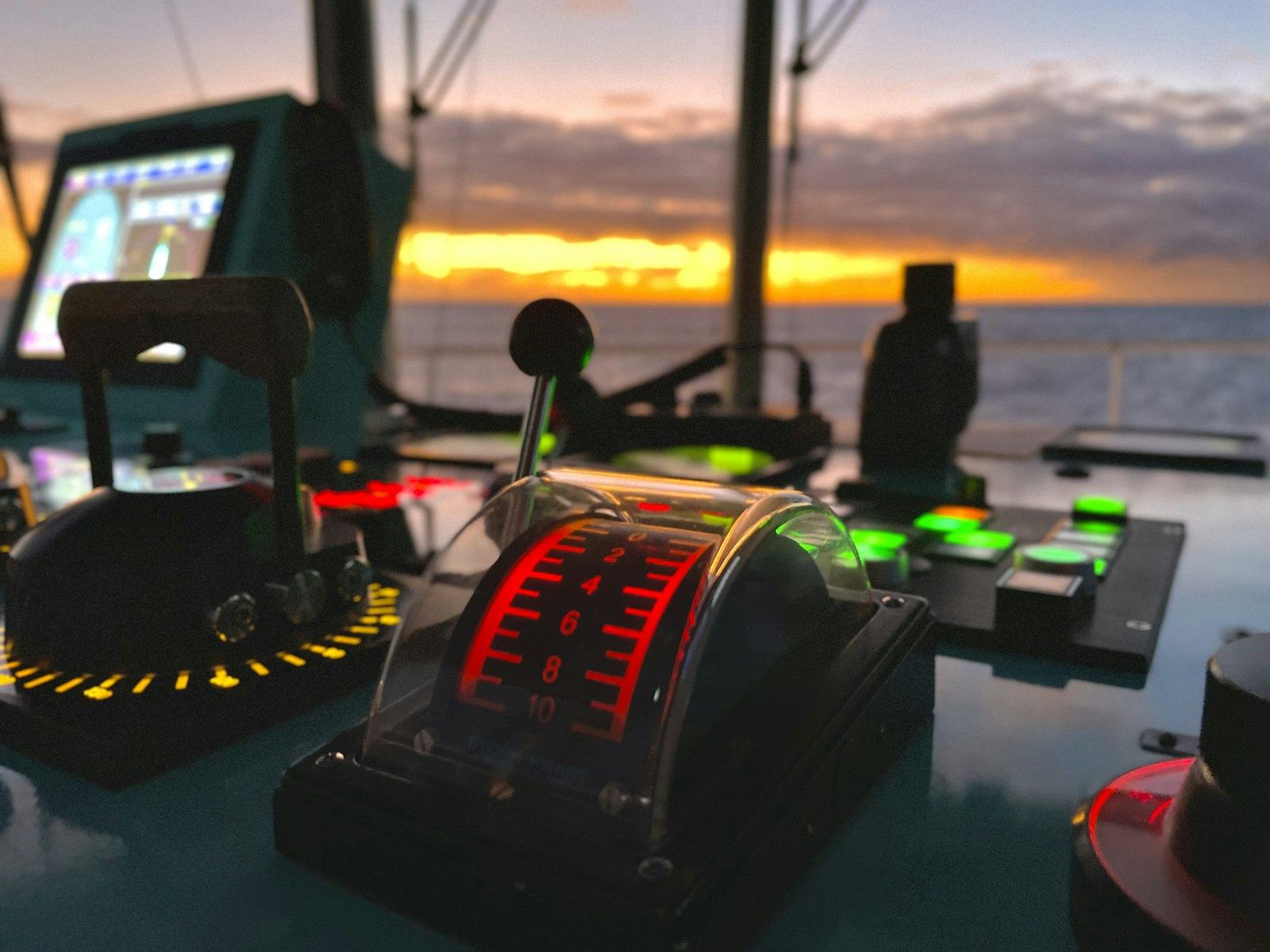 Helm console with a marine display, throttle controls, and navigation instruments